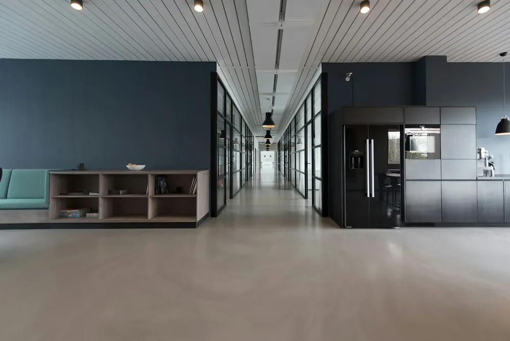 Polished office hallway with glass walls
