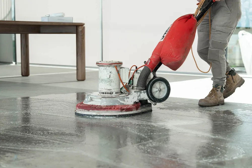 Floor cleaning machine polishing a new tile floor