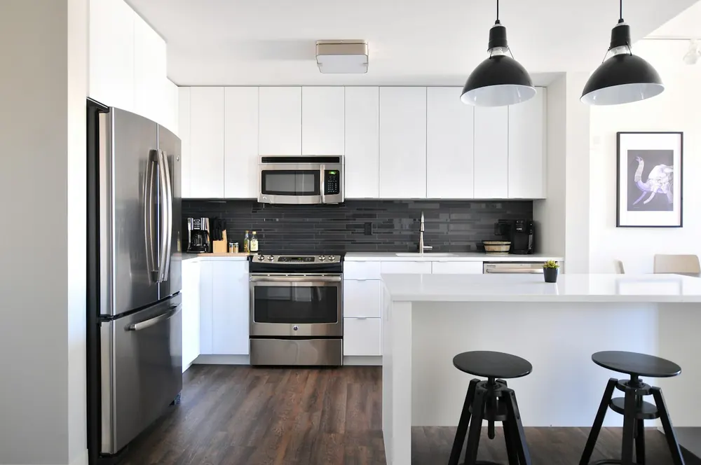 White kitchen with clean counters and cabinetry